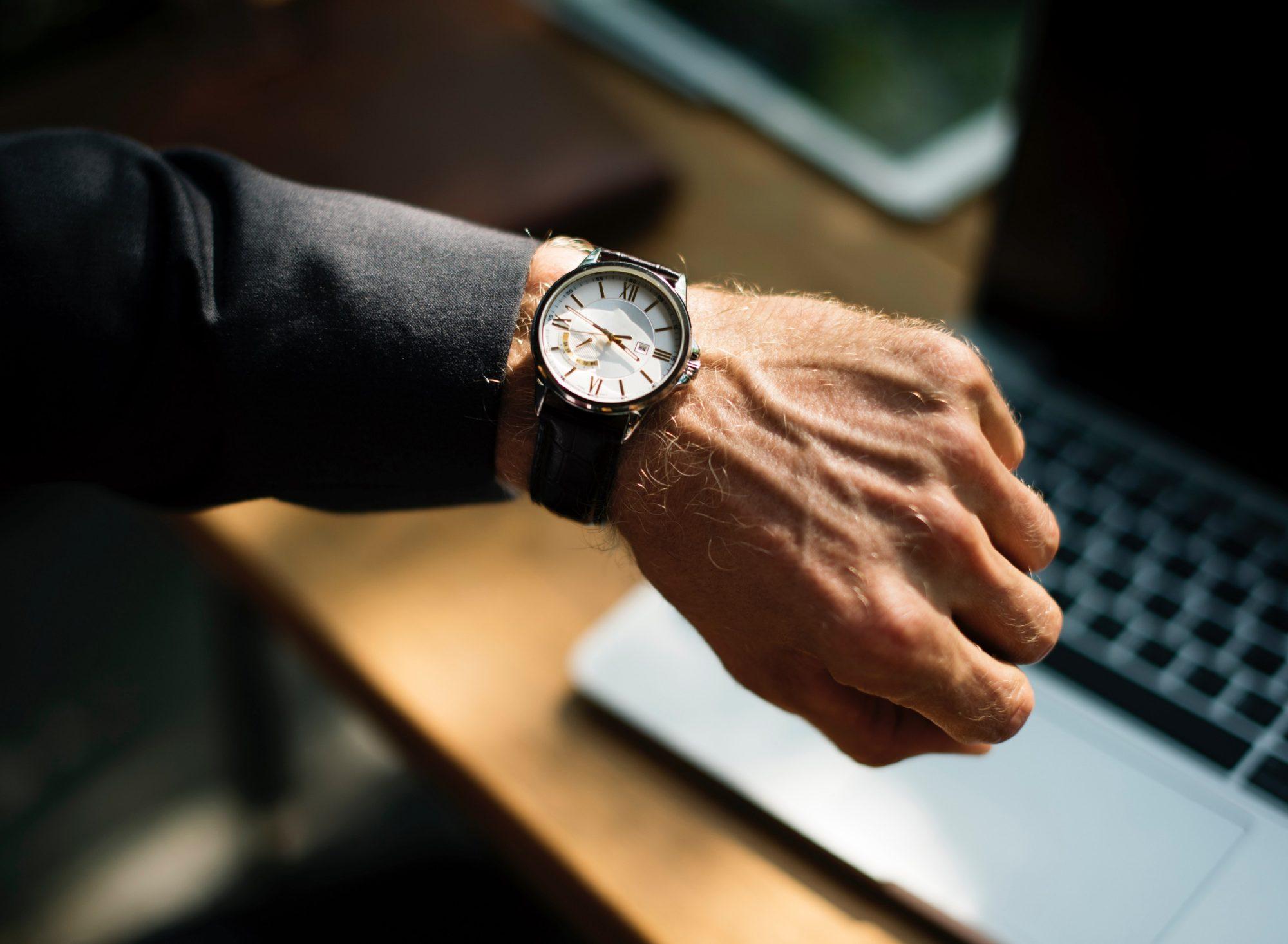 264525 a man in a black suit checking the time on an eleg 1 264525 a man in a black suit checking the time on an eleg 1
