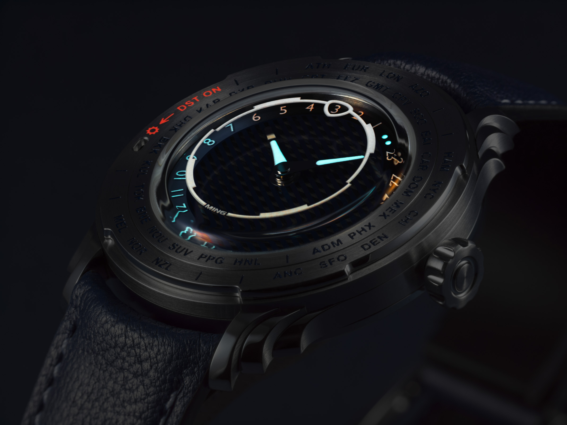 6a7ce568a32e0823cc27de0e 907X B0008970 Ceas MING 57.05 Comet cu cadran negru texturat, marcaje albastre luminoase și bezel cu inscripții pentru fusuri orare.